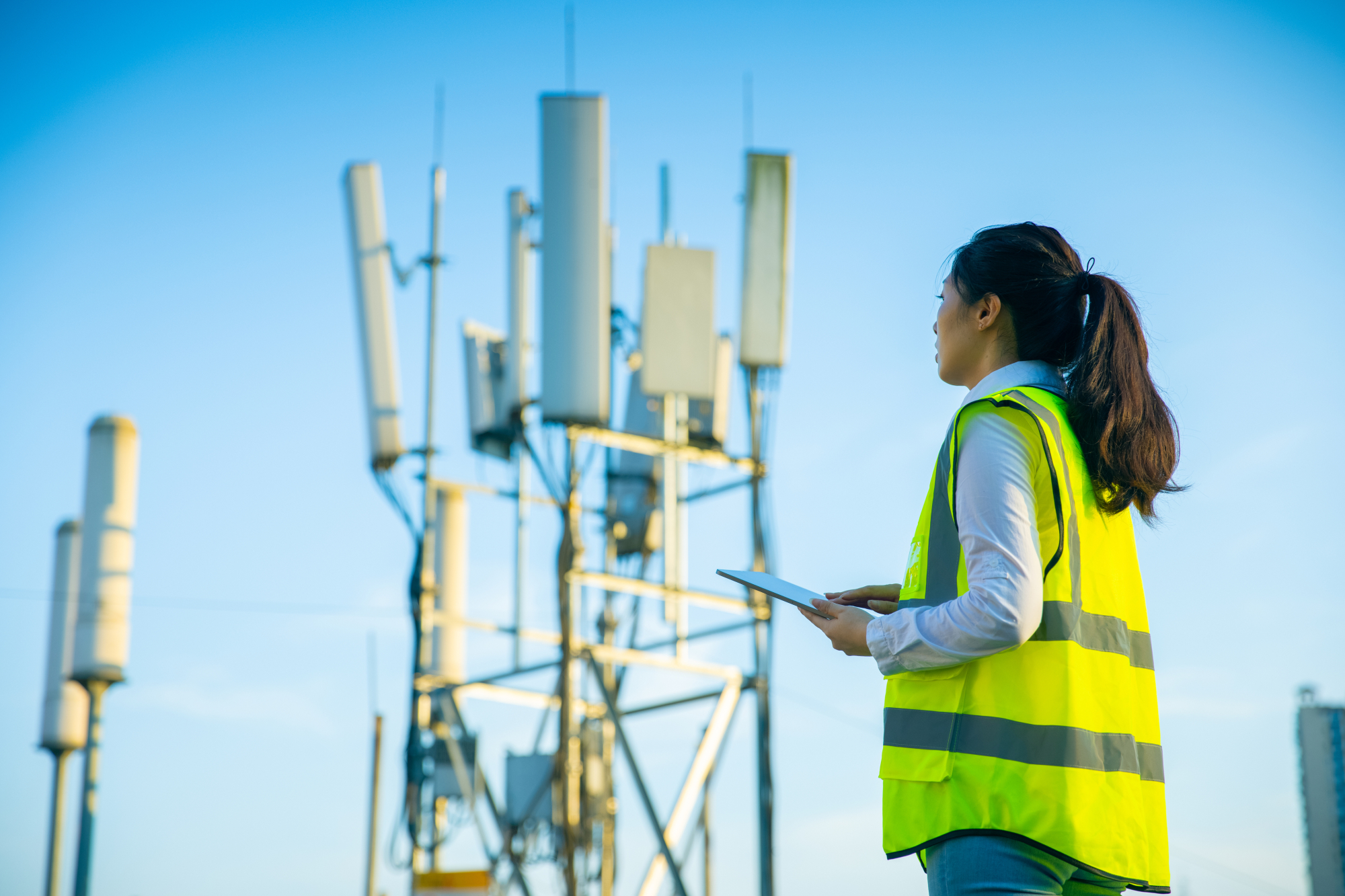 Female engineer working at a telecommunications tower