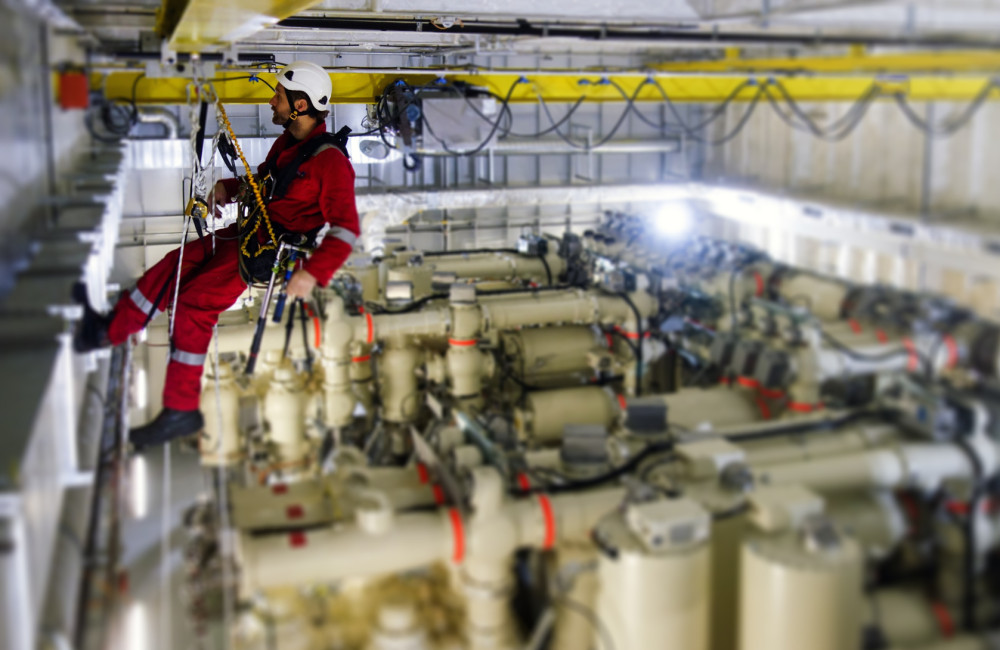 Technician making inspection of crane railing