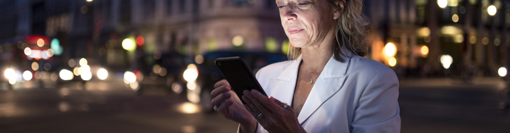 Business woman using phone in London