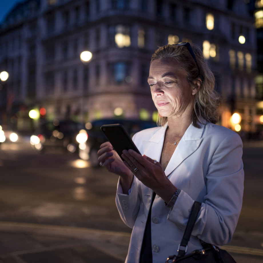 Business woman using phone in London