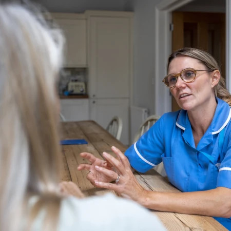 Female nurse at patients home