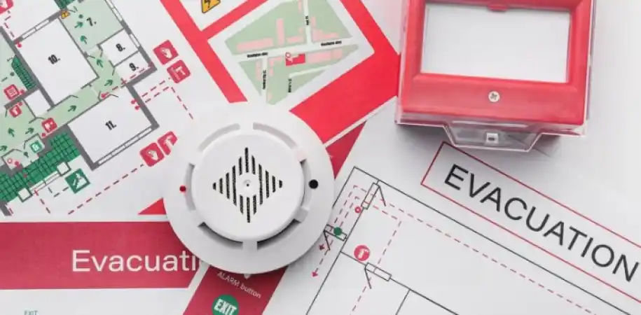 Fire alarm call point and smoke detector on a building evacuation plan