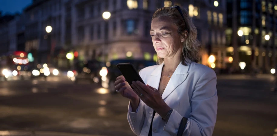 Business woman using phone in London