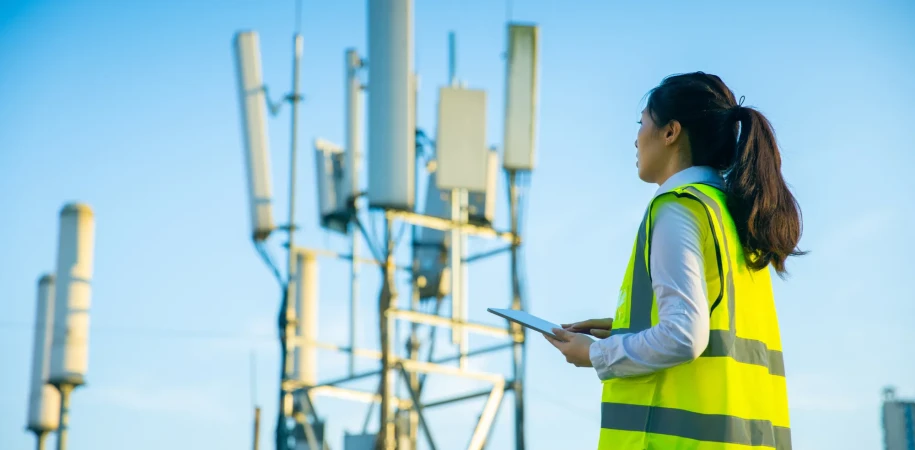Female engineer working at a telecommunications tower