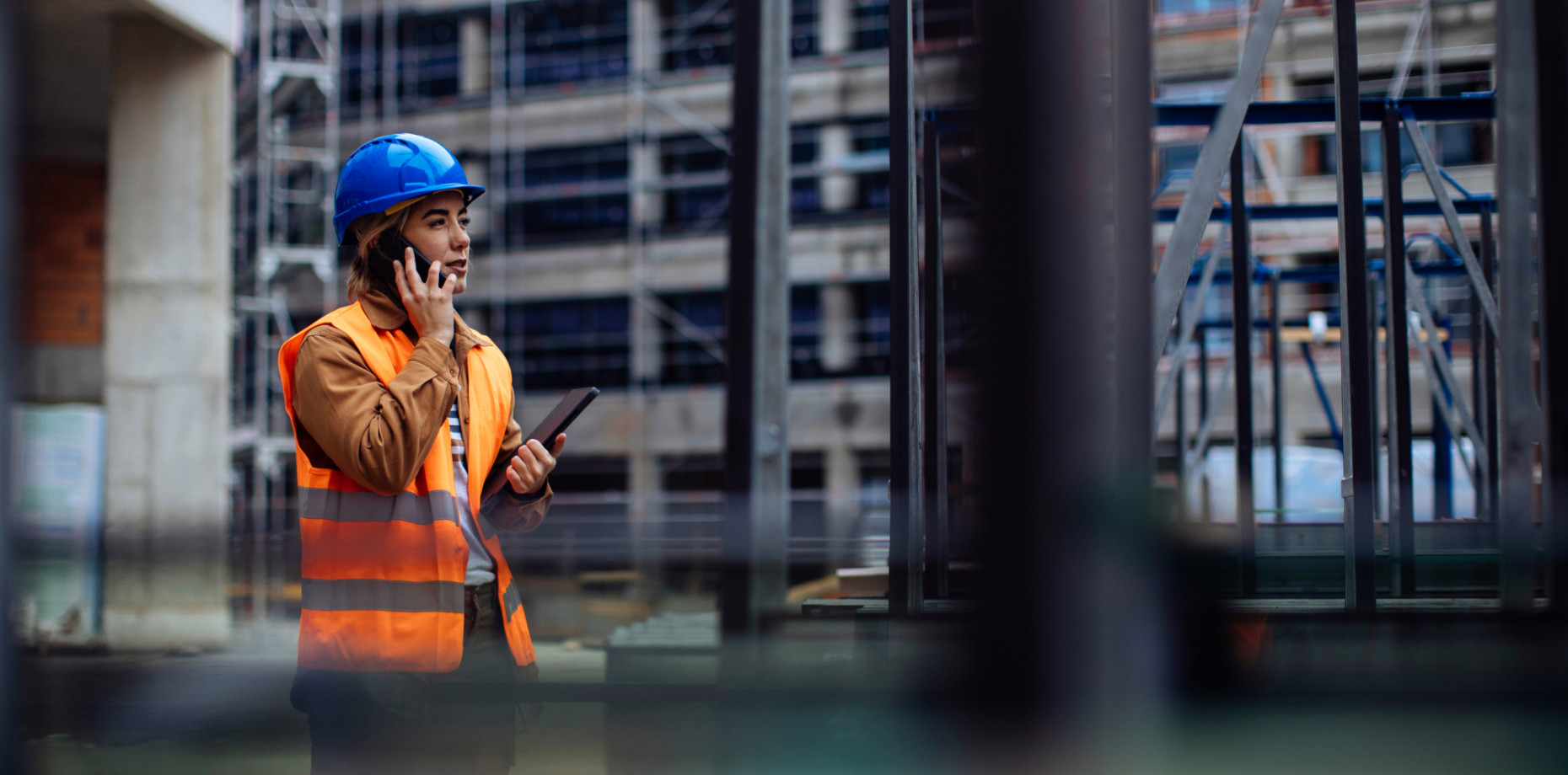Female worker on the phone at a construction site