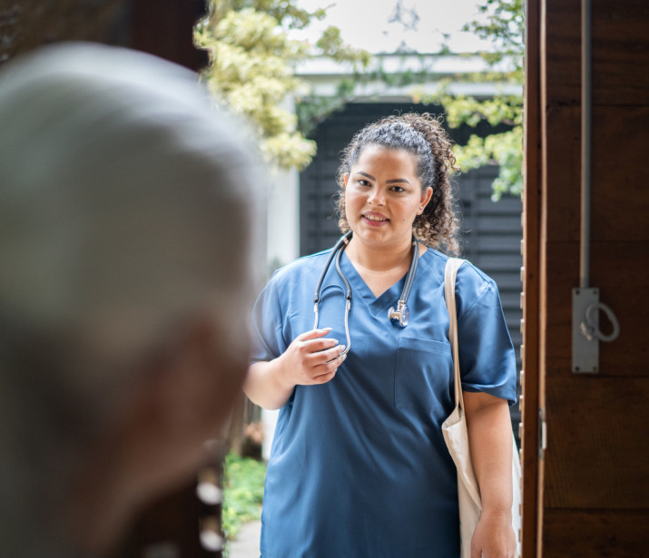 Nurse visiting patient at their home