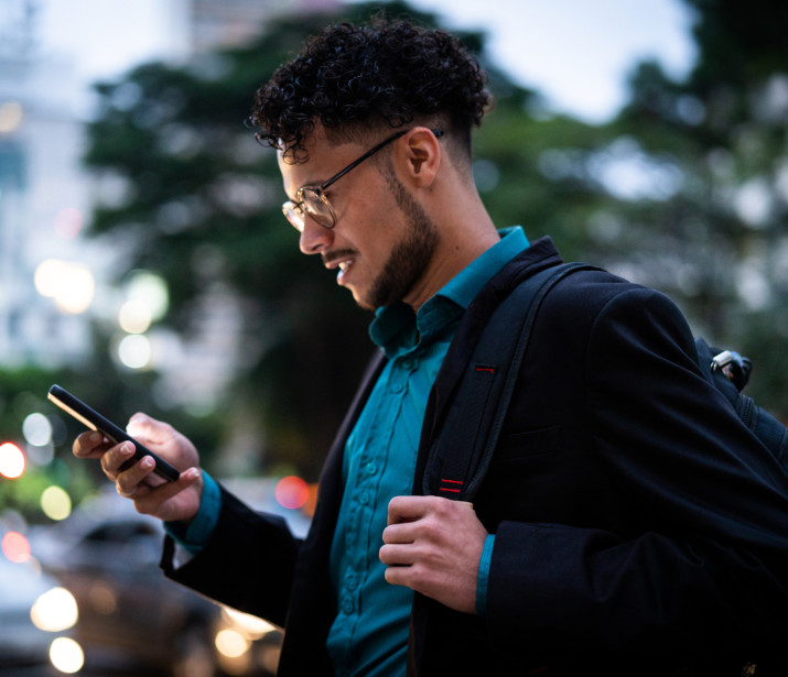 Man using phone at night outside