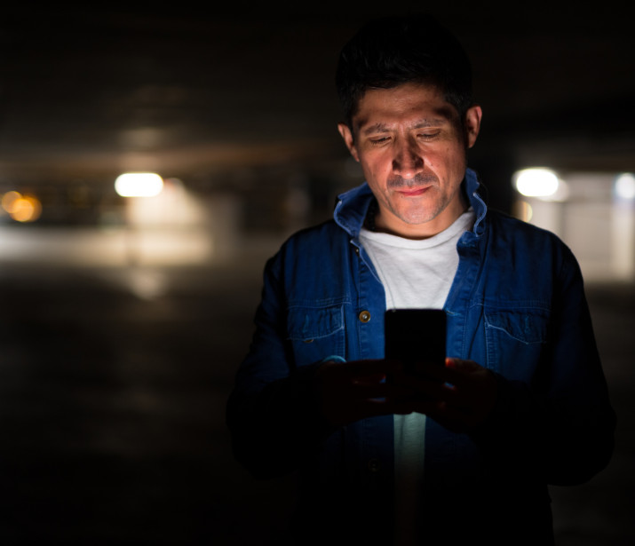 Man using phone at night