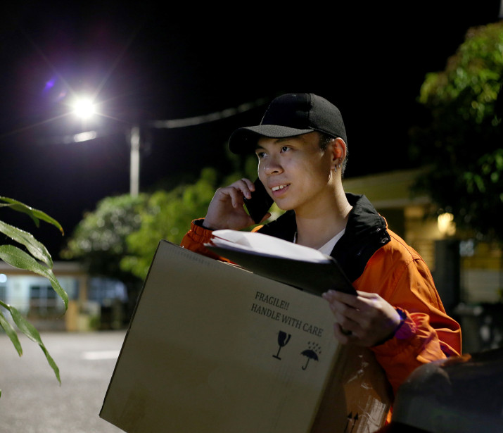 Male delivery driver at night
