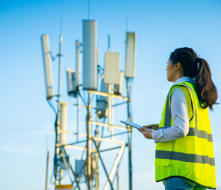 Female engineer working at a telecommunications tower