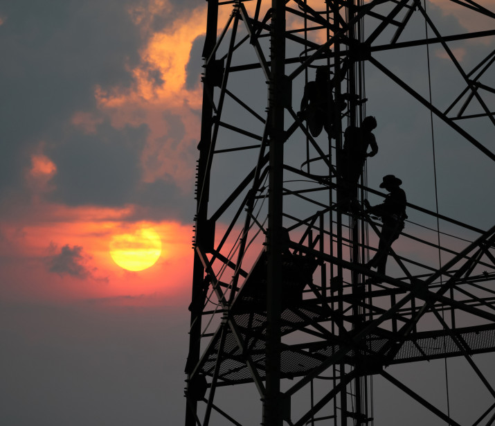 Workers repairing the telecommunication towee